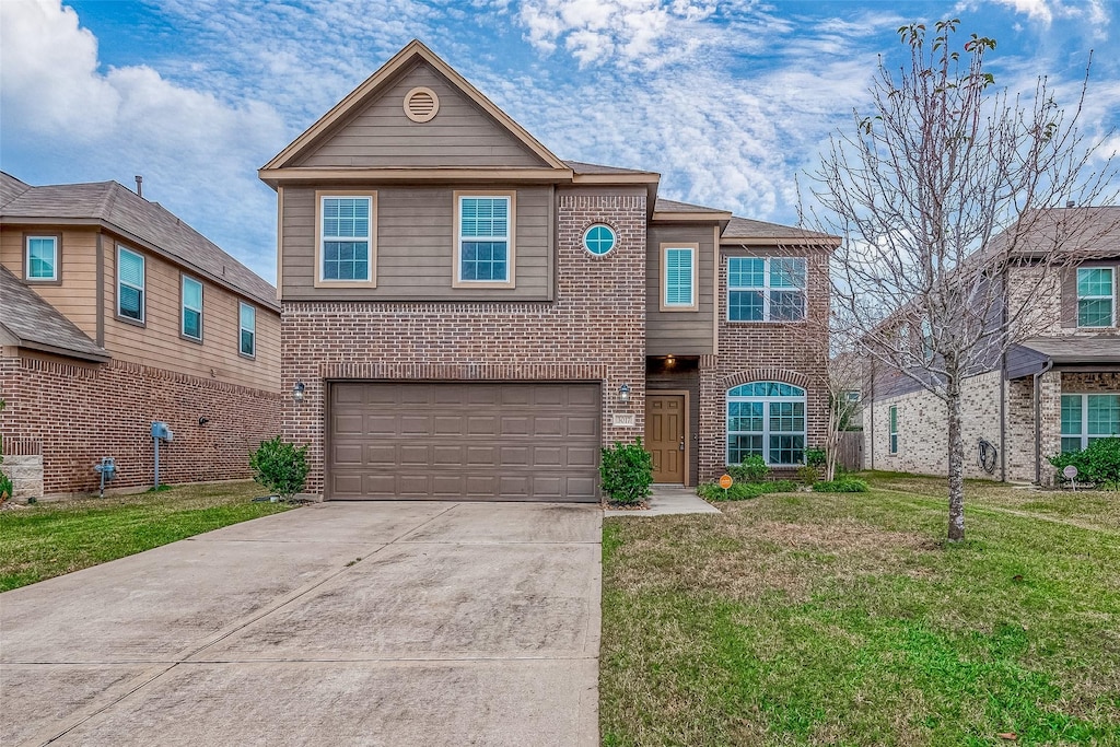 view of front of property featuring a garage and a front lawn