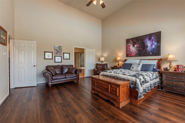 bedroom with connected bathroom, ceiling fan, high vaulted ceiling, and dark wood-type flooring