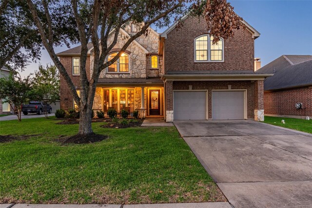 view of front facade with a yard and a garage