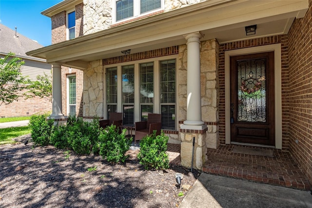 view of exterior entry with a porch