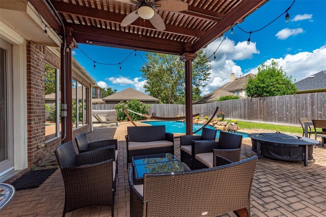 view of patio featuring outdoor lounge area, ceiling fan, a fenced in pool, and a pergola