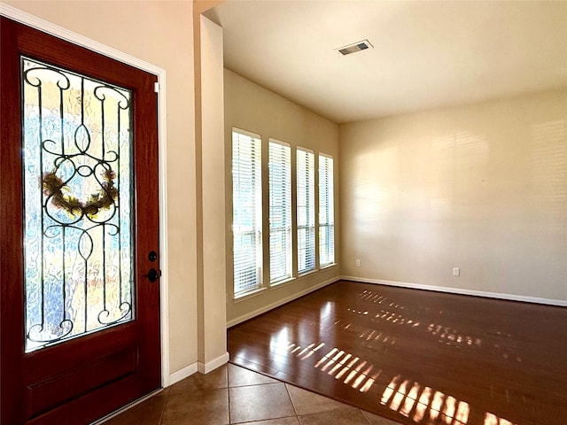 foyer featuring dark tile patterned flooring