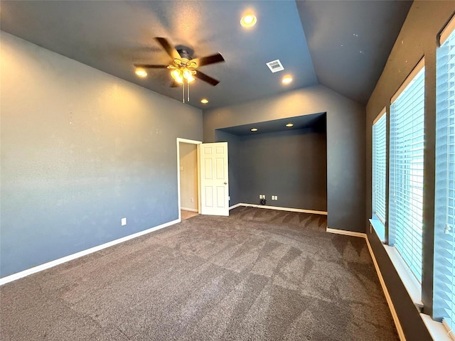 unfurnished bedroom featuring ceiling fan, lofted ceiling, and dark colored carpet