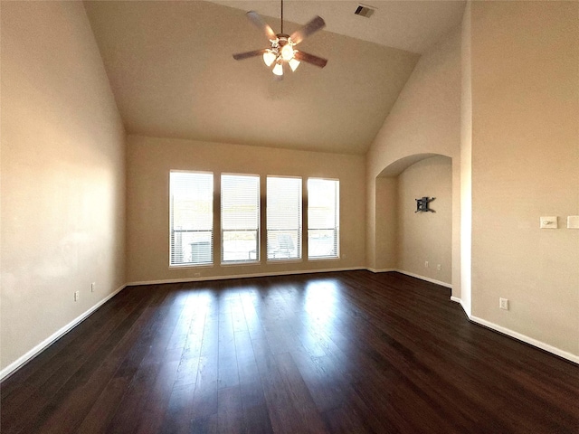 unfurnished room featuring dark hardwood / wood-style floors, vaulted ceiling, and ceiling fan