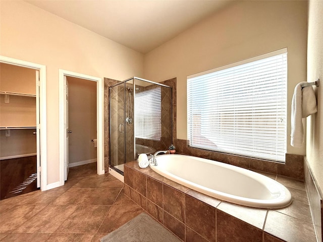 bathroom with plus walk in shower and tile patterned flooring