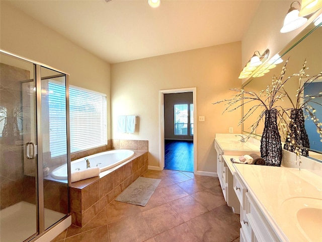 bathroom with vanity, tile patterned flooring, and plus walk in shower