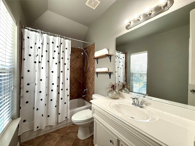 full bathroom with vanity, vaulted ceiling, shower / bath combo with shower curtain, tile patterned flooring, and toilet