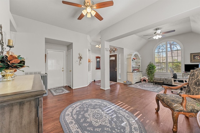 living area with lofted ceiling, visible vents, ceiling fan, wood finished floors, and baseboards