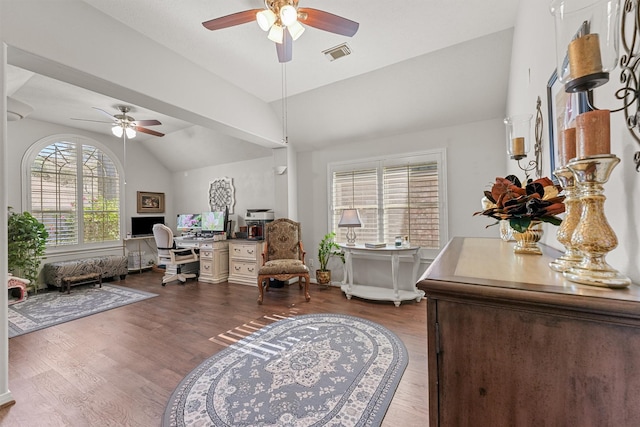 office area featuring a ceiling fan, lofted ceiling, visible vents, and wood finished floors