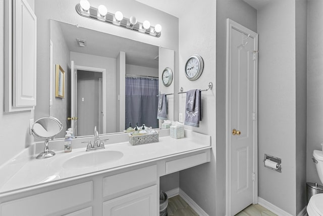 full bathroom featuring toilet, baseboards, visible vents, and vanity