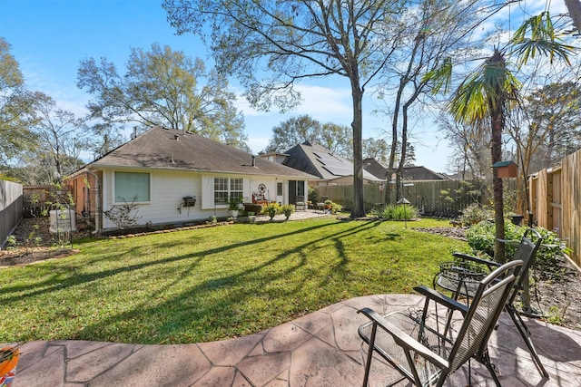 back of house with a patio area, a yard, and a fenced backyard