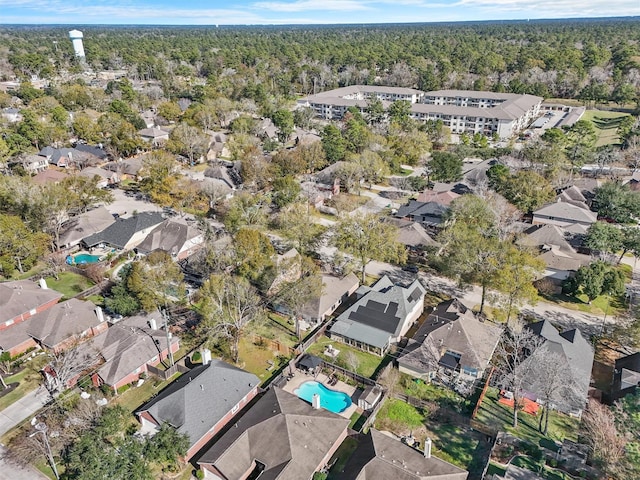 birds eye view of property featuring a residential view and a wooded view