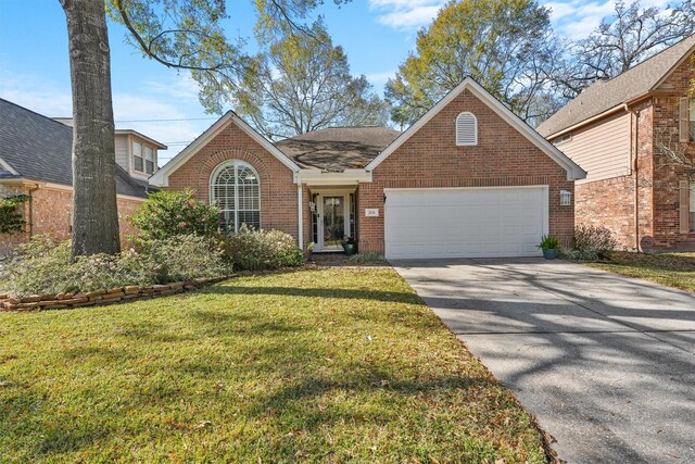 view of property featuring a front yard and a garage