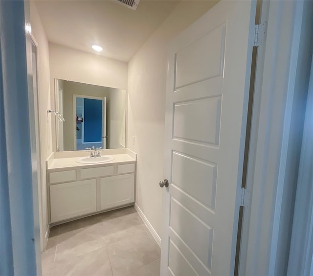 bathroom with tile patterned floors and vanity