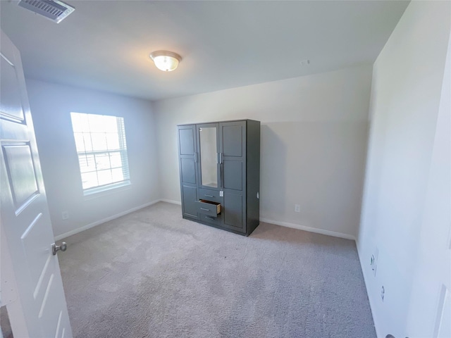 unfurnished bedroom with light carpet