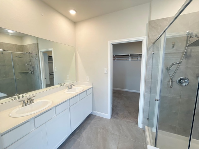 bathroom with tile patterned floors, vanity, and walk in shower