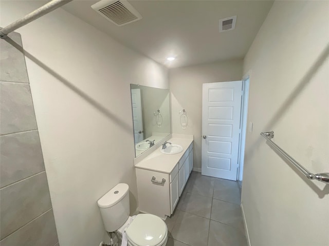 bathroom featuring tile patterned flooring, vanity, and toilet