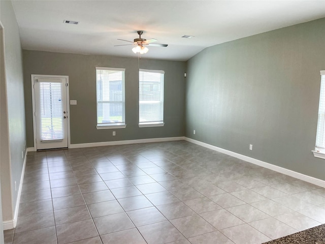 empty room with ceiling fan and light tile patterned floors