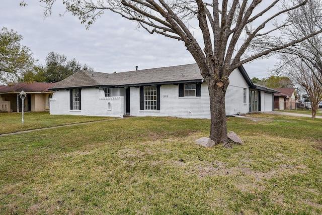 view of front of house with a garage and a front yard