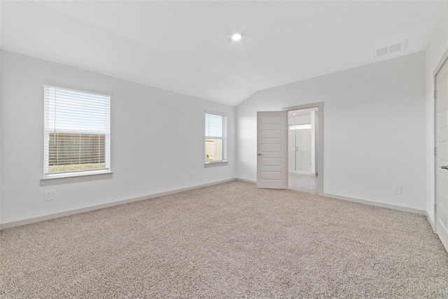 unfurnished bedroom with lofted ceiling and carpet floors