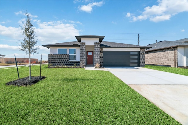 prairie-style home featuring a garage and a front lawn