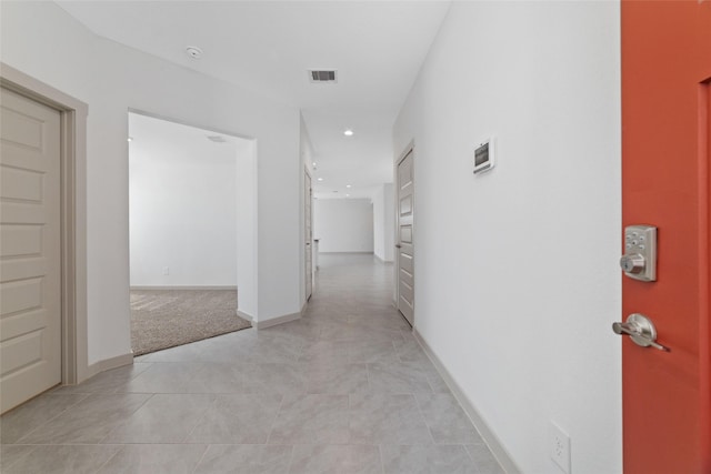 hall featuring light tile patterned floors