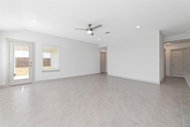 spare room with ceiling fan, lofted ceiling, and light tile patterned flooring