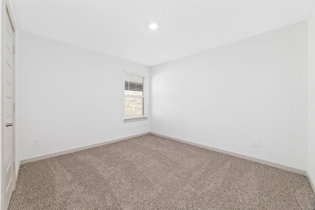 unfurnished room featuring carpet