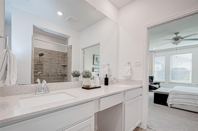 bathroom featuring ceiling fan, vanity, and tiled shower