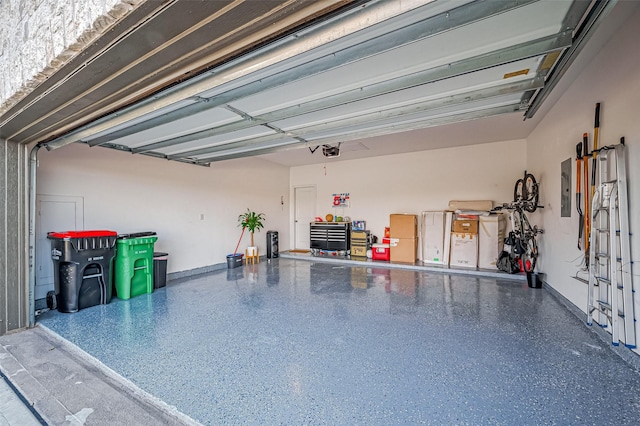 garage with electric panel and a garage door opener