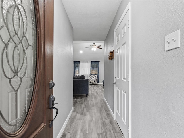 hallway with light hardwood / wood-style flooring