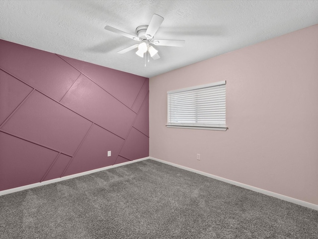 spare room with carpet flooring, ceiling fan, and a textured ceiling