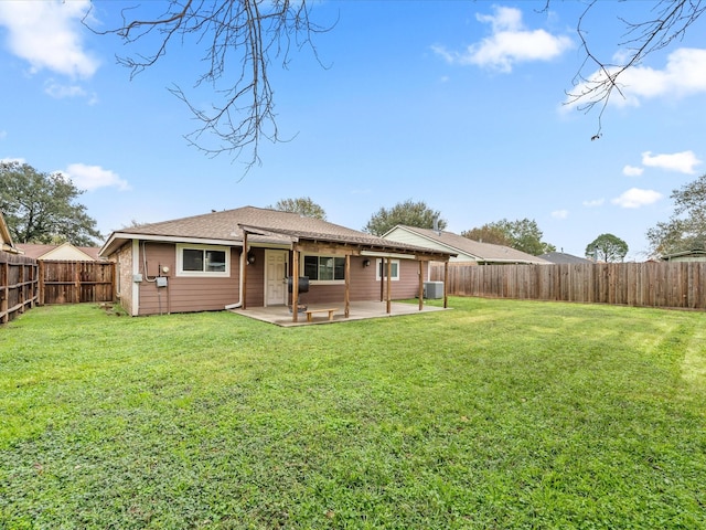 back of house with a yard, cooling unit, and a patio area