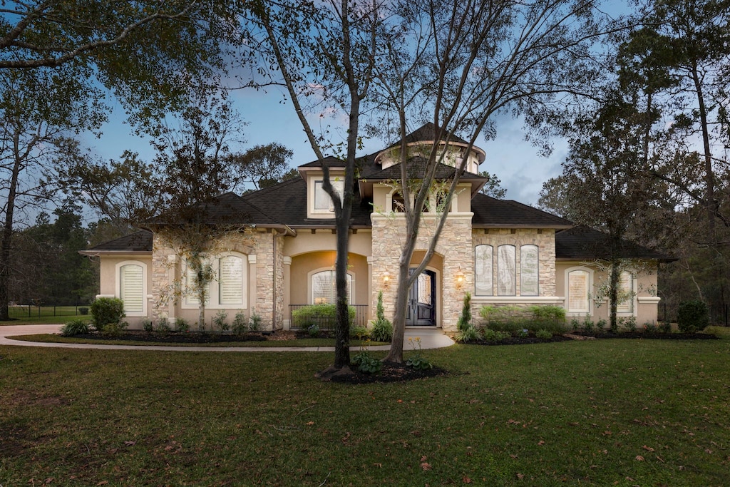 mediterranean / spanish-style house featuring a front lawn