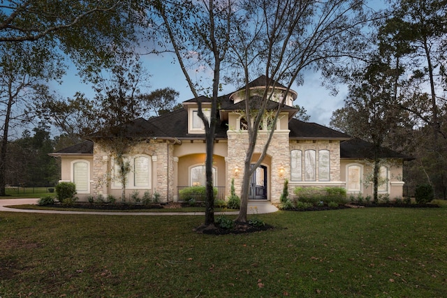 mediterranean / spanish-style house featuring a front lawn