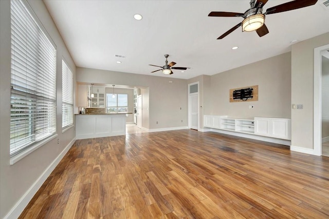 unfurnished living room with ceiling fan and light hardwood / wood-style flooring