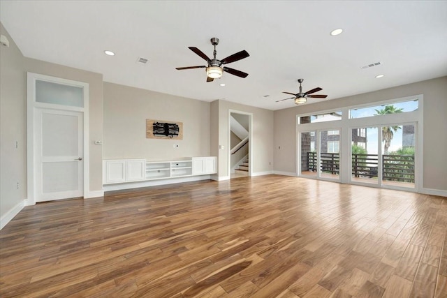 unfurnished living room with hardwood / wood-style floors and ceiling fan