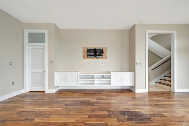 unfurnished living room featuring hardwood / wood-style flooring