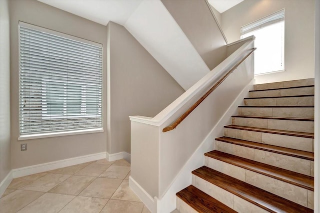 stairway with tile patterned flooring and a healthy amount of sunlight