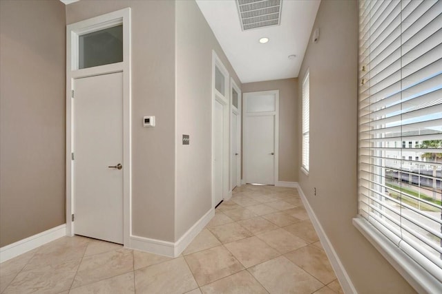 hallway with light tile patterned floors