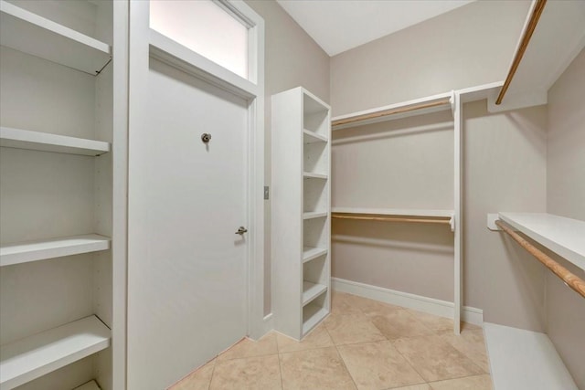 spacious closet with light tile patterned floors