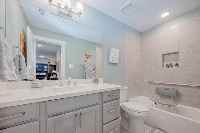 bathroom featuring a bathtub, vanity, and toilet