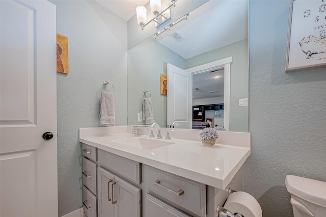 bathroom with vanity and toilet