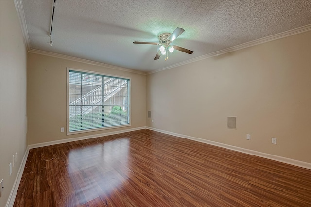 unfurnished room featuring a textured ceiling, wood-type flooring, and crown molding