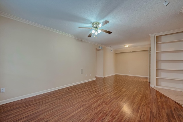 unfurnished room featuring hardwood / wood-style floors, ceiling fan, crown molding, and a textured ceiling