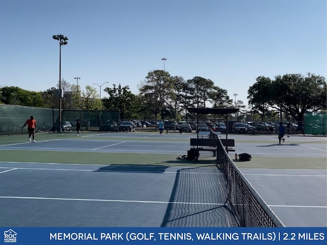 view of tennis court featuring basketball hoop