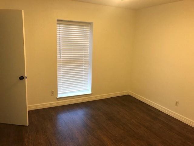 empty room featuring dark wood-type flooring