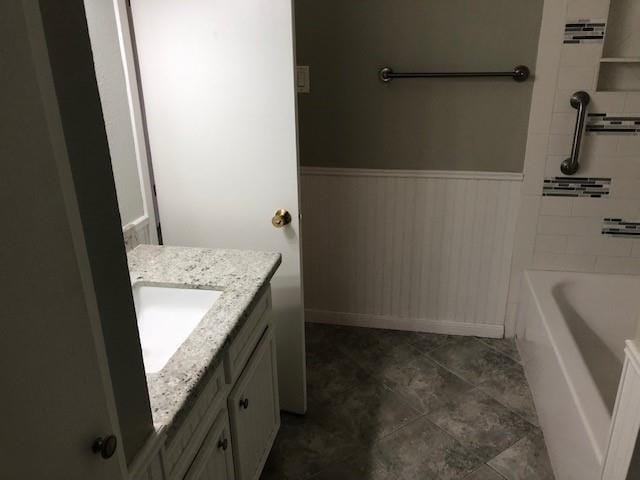 bathroom with vanity and a bath