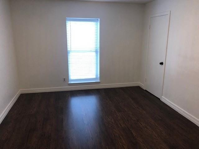 spare room featuring dark hardwood / wood-style flooring