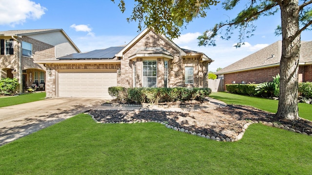 view of front of home featuring solar panels, a garage, and a front lawn